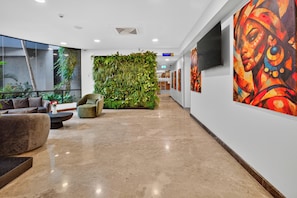 A modern lobby with a green living wall, comfortable seating, and artwork on the walls. - PrideInn Azure Hotel Nairobi Westlands (Nairobi)