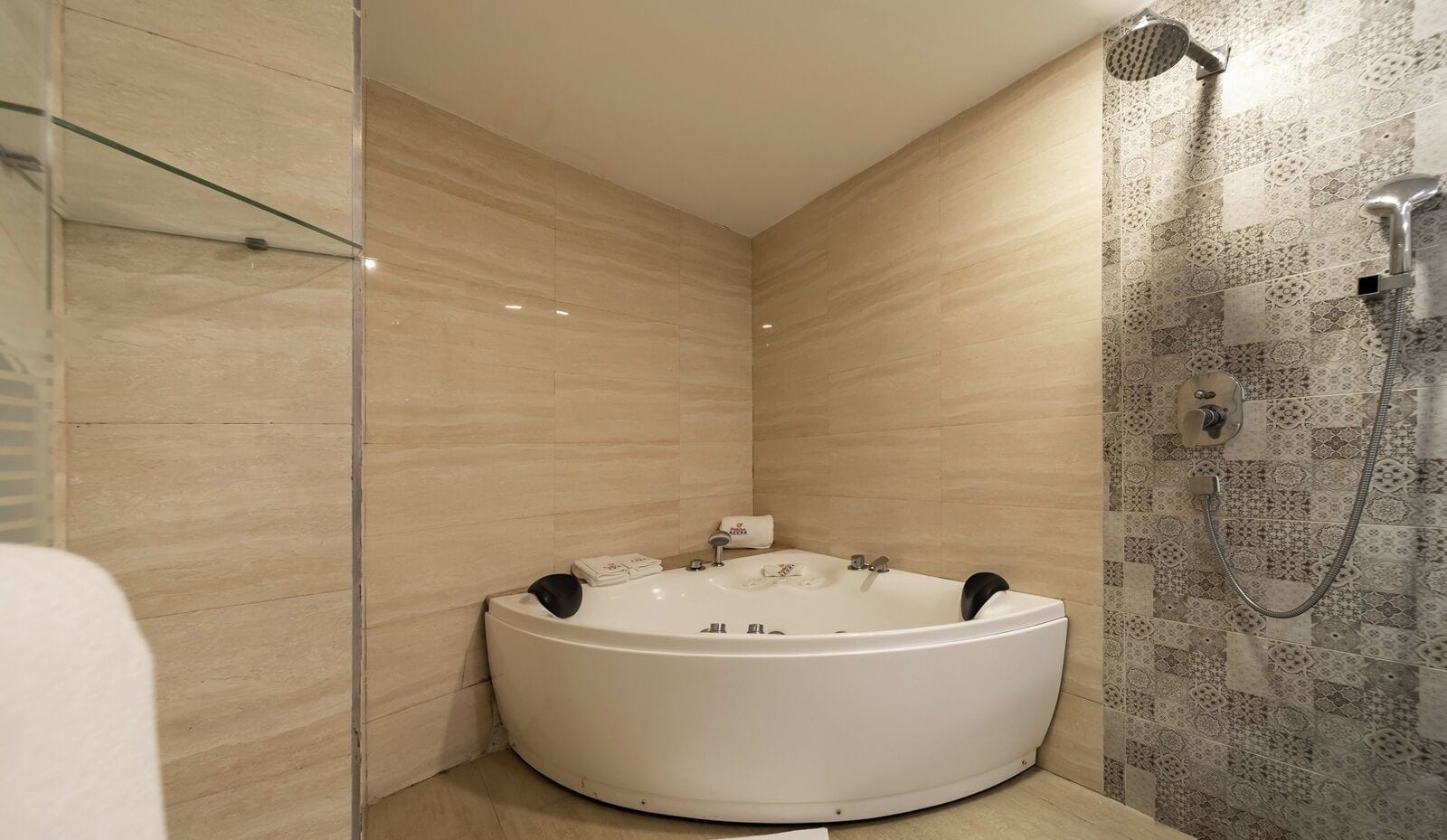 Une salle de bain moderne avec une baignoire sur pieds, un espace douche et des carreaux décoratifs sur les murs.