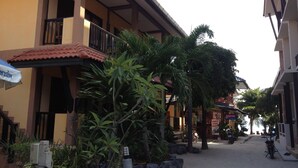 A building with a red-tiled roof, balconies, and a sign for a bike rental service. - Rin Bay View Resort (Ko Pha-ngan)
