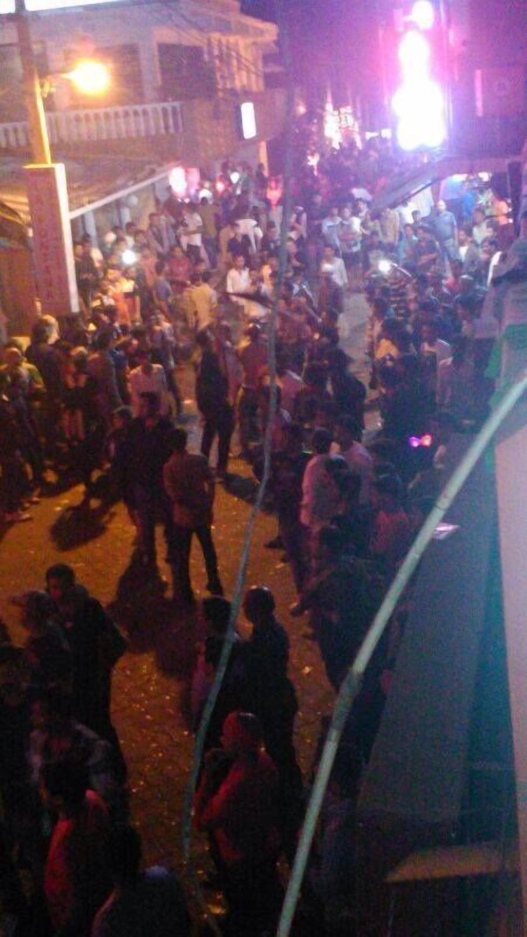 A crowded outdoor area with people gathered, possibly for an event or gathering.