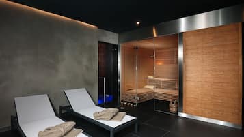Relax in a serene space with two reclining chairs, a bathtub, and a glass partition separating the seating area from a relaxation space.