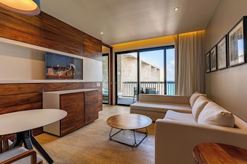 Suite (The Horizon) | Living area | 47-inch flat-screen TV with cable channels, TV, books at Devossion By Live Aqua Playa del Carmen All Inclusive - Adults Only