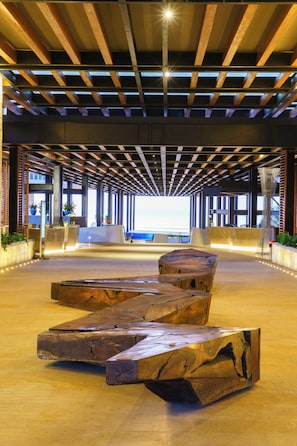 A spacious lobby with a wooden ceiling, a reception desk, and a large window. - Devossion By Live Aqua Playa del Carmen All Inclusive - Adults Only (Playa del Carmen)