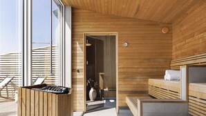 Una sauna moderna con bancos de madera y un ventanal grande.