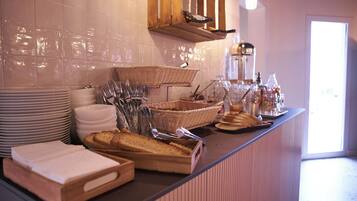 A buffet setup with various food items and utensils.