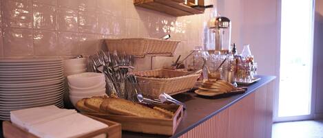 A buffet setup with various food items and utensils.