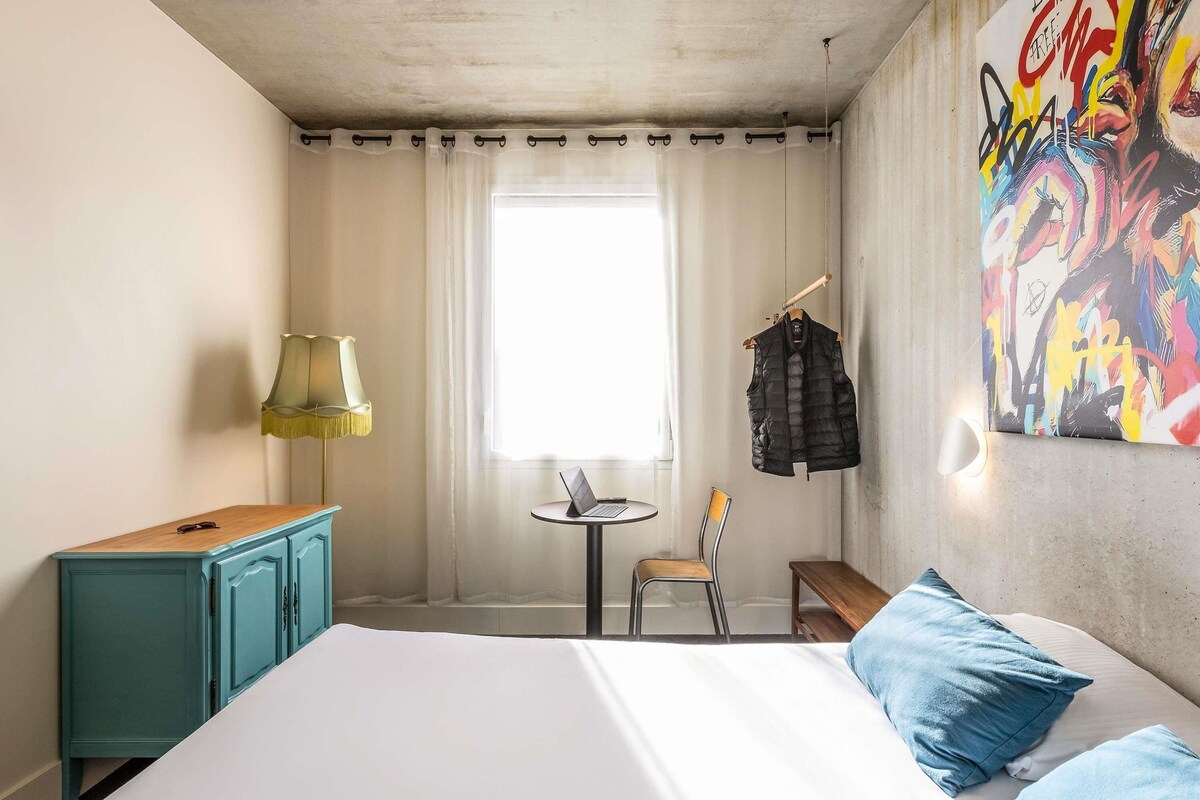 Premium bedding, desk, laptop workspace, blackout drapes