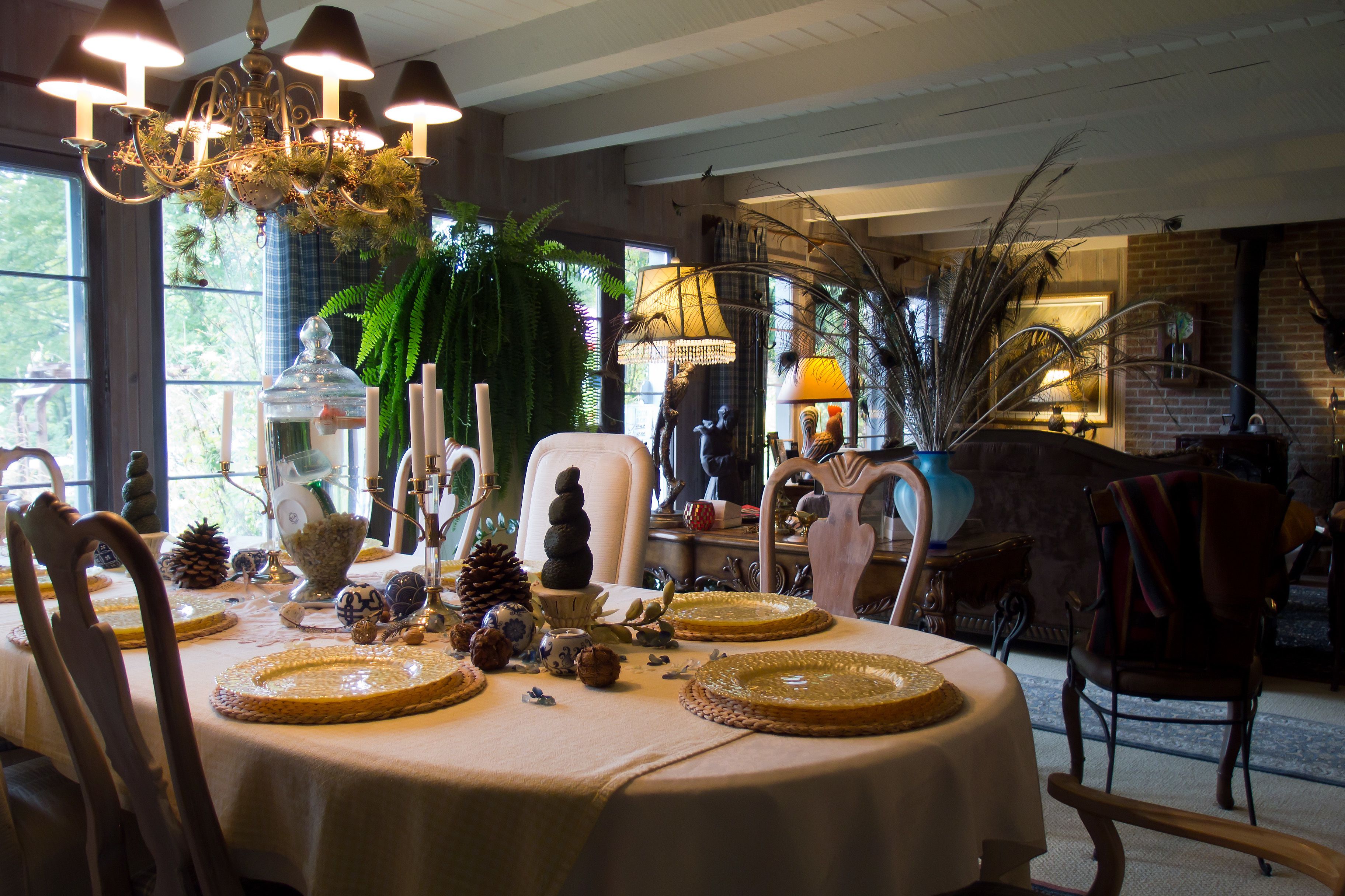 A dining area with a round table set for four, surrounded by chairs.