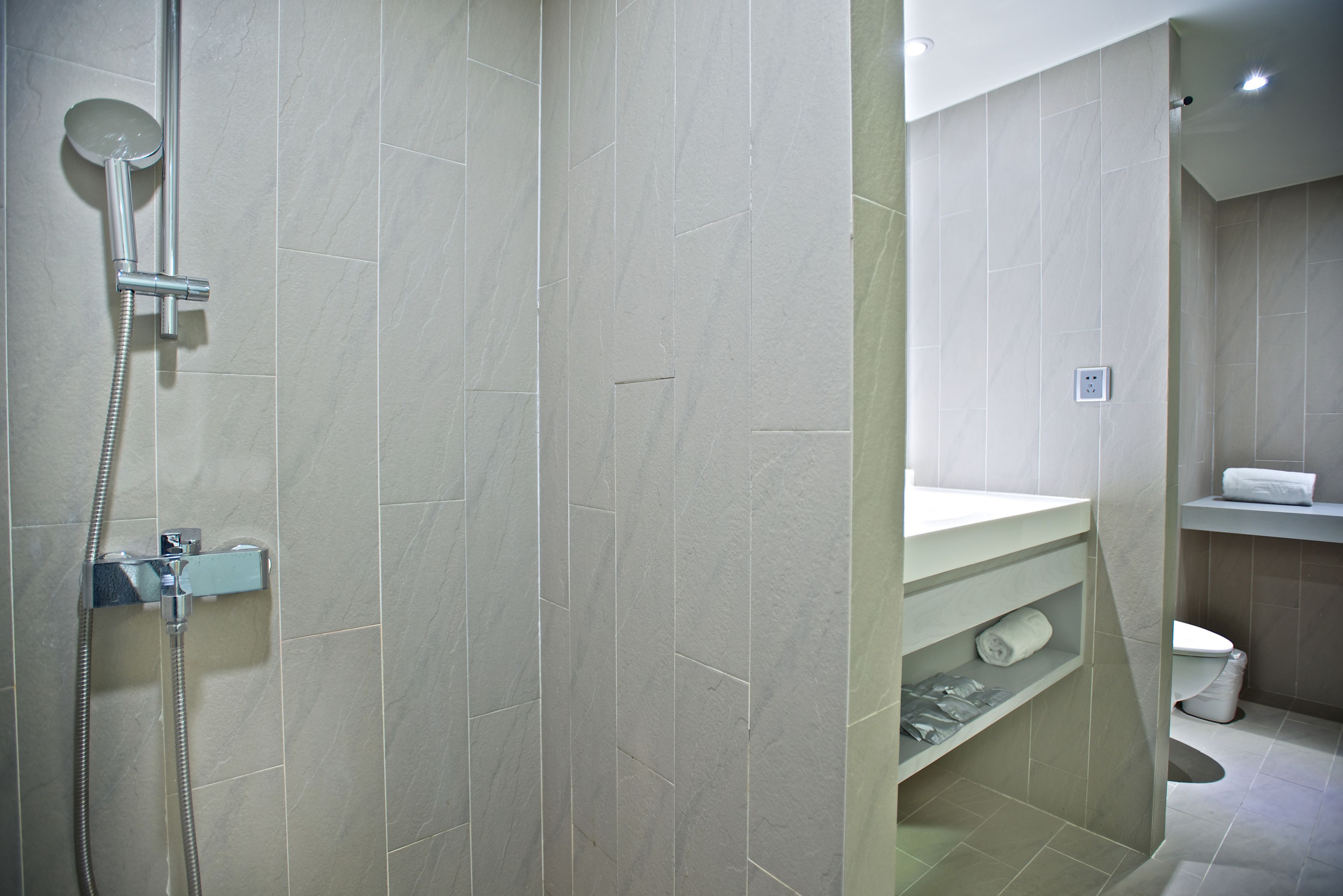 shower, hair dryer, slippers, towels