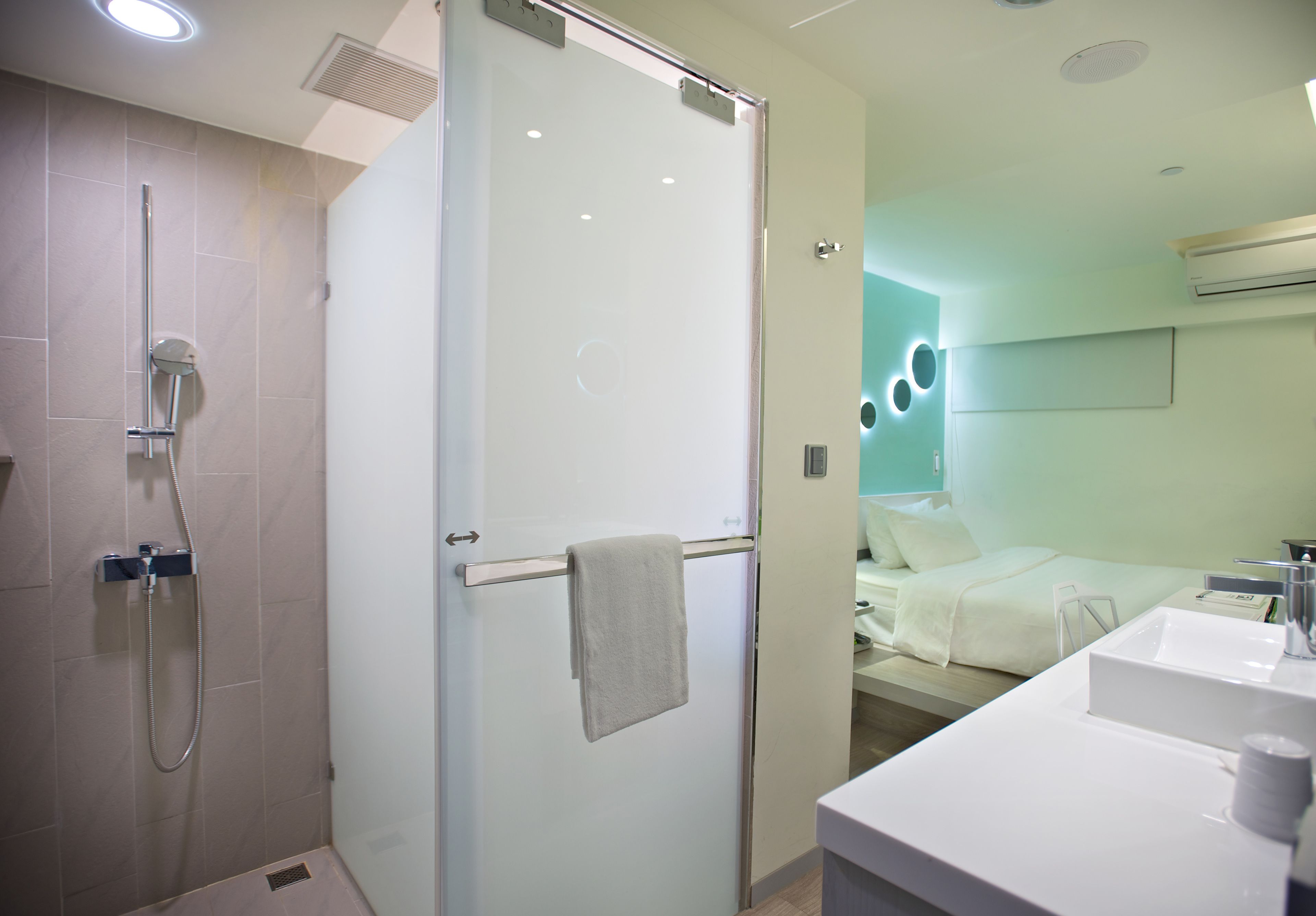 shower, hair dryer, slippers, towels