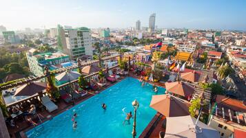 Relax by the rooftop pool surrounded by modern buildings.