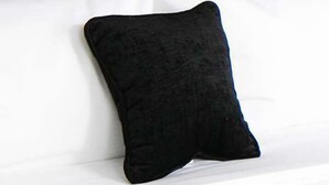 A bed with white bedding and a single black pillow. - Red Lion Inn & Suites La Pine (La Pine)