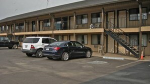 A multi-story motel with a parking lot. - Red Lion Inn & Suites La Pine (La Pine)