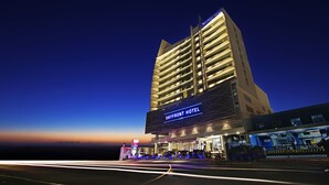 A multi-story hotel with a prominent sign reading "Bayfront Hotel Cebu".