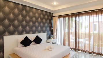 Deluxe Room, Pool View | Minibar, in-room safe, blackout drapes, rollaway beds