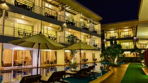 A multi-story hotel with a swimming pool, outdoor seating, and balconies. - Milano Hua Hin (Hua Hin)