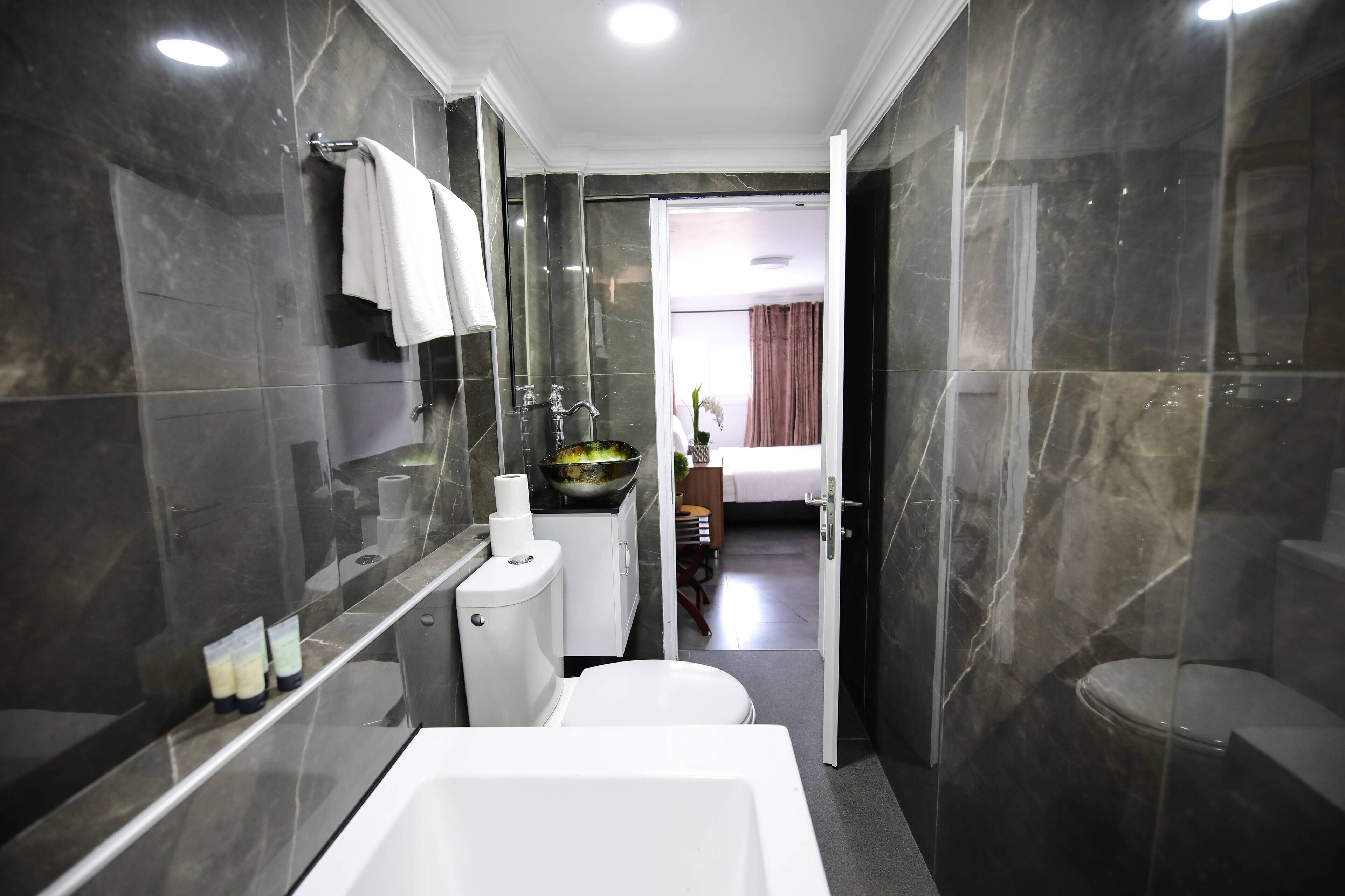 classic double room with bath | bathroom | rainfall showerhead, hair dryer, slippers, towels