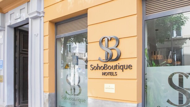 A building facade with the signage "SohoBoutique Hotels" and a large glass window. - Soho Boutique Malaga (Málaga)