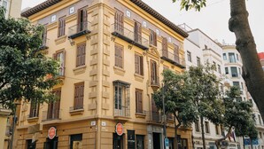 A yellow building with multiple balconies and a sign indicating a restaurant. - Soho Boutique Malaga (Málaga)