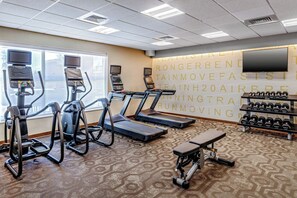 A gym with treadmills, elliptical machines, a bench, and dumbbells. - Residence Inn Nashua (Nashua)