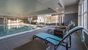 A swimming pool area with lounge chairs and a sunbed.