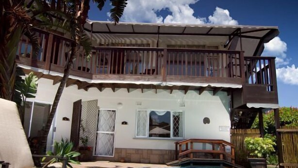 A two-story house with a swimming pool, a balcony, and a wooden fence. - Boma Lodge (Durban North)