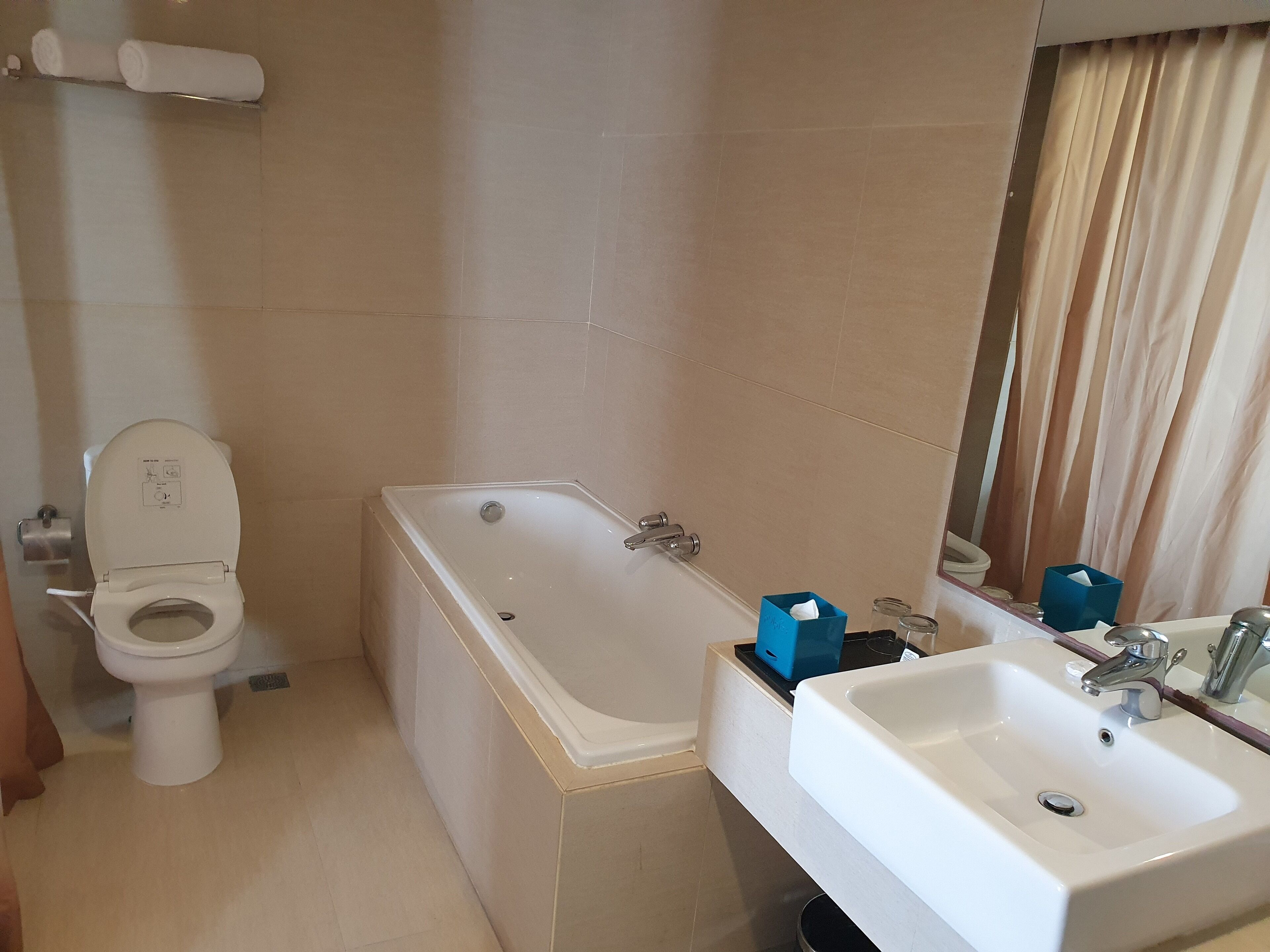 A bathroom with a toilet, a bathtub, and a sink.
