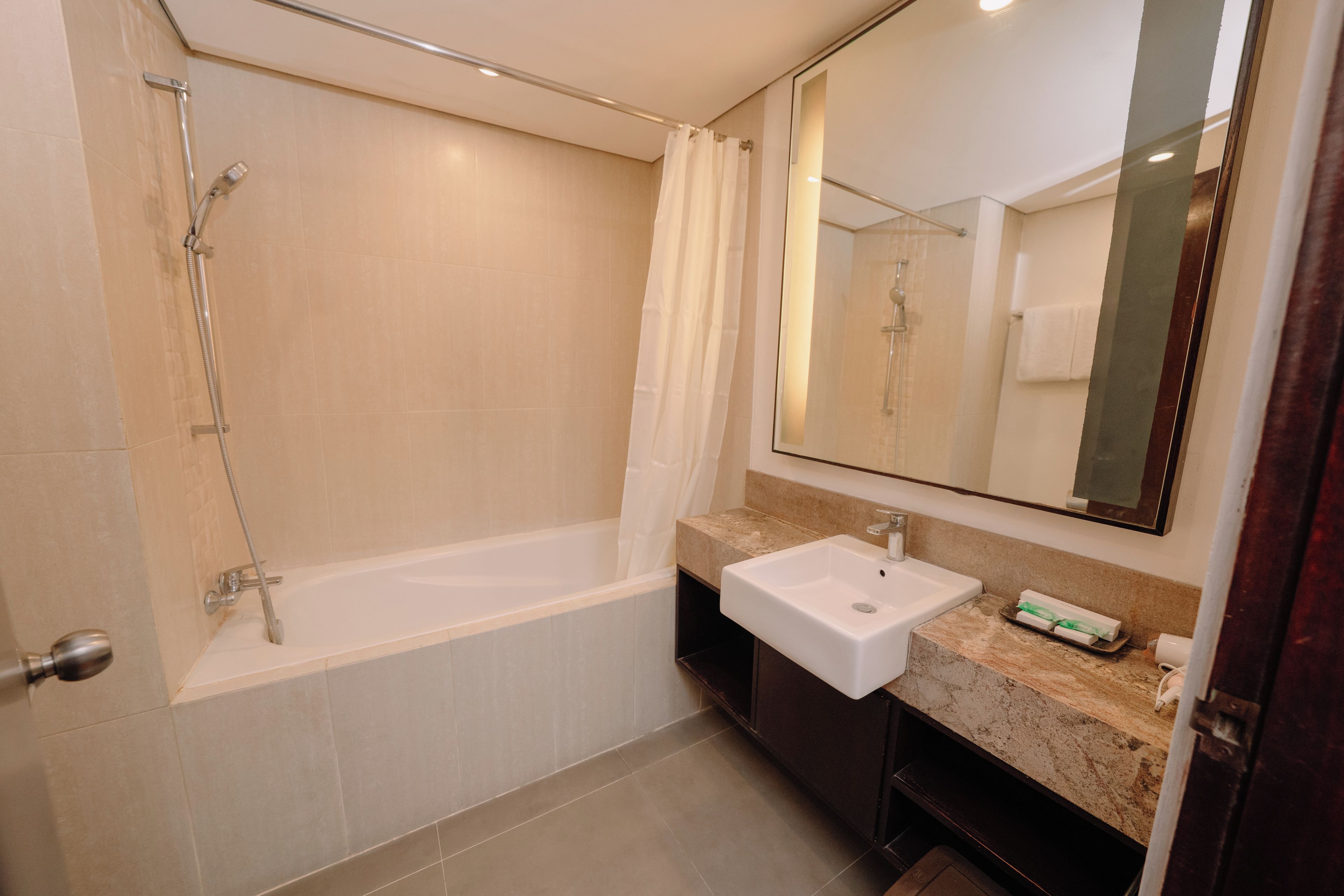 Un baño moderno con bañera, lavabo y espejo.