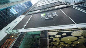 A modern building with a glass facade and a sign reading "Club".