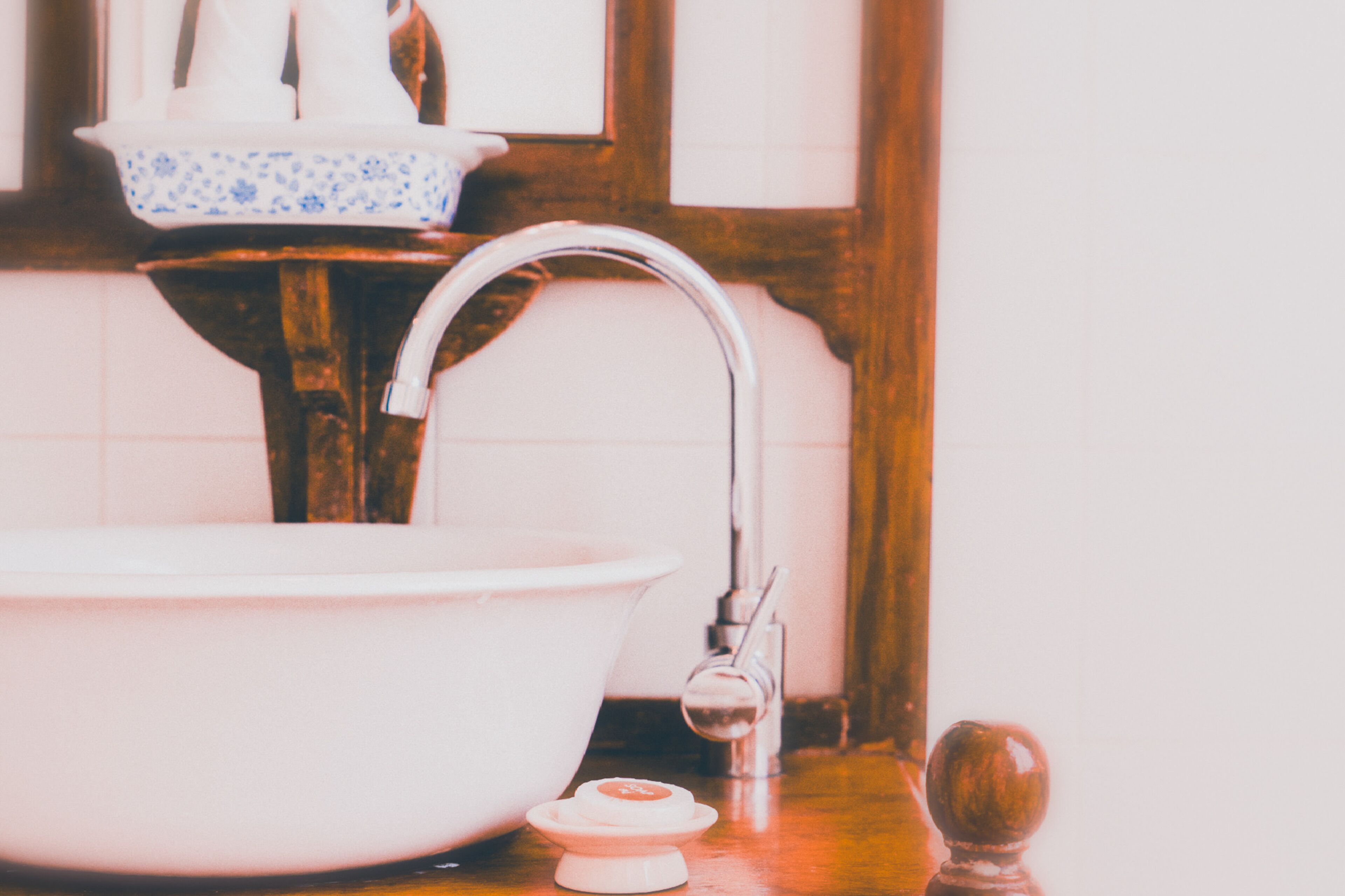 A bathroom sink with a faucet and a soap dish.