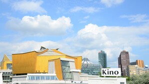 A modern building with a large sign reading "Kino" in front.