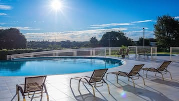 Outdoor pool, open 10:00 AM to 10:00 PM, pool loungers