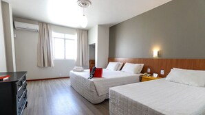 A hotel room with two beds, a desk, and a wardrobe. - Itajai Express (Itajai)