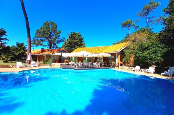 Seasonal outdoor pool, open 9:30 AM to 8:00 PM, pool umbrellas