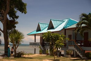 A beachfront property with two buildings featuring blue roofs and a staircase leading to a balcony. - Sun Sea Resort (Ko Pha-ngan)