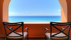 Two chairs facing a window with a view of the ocean. - Casa del Mar Condos (San José del Cabo)