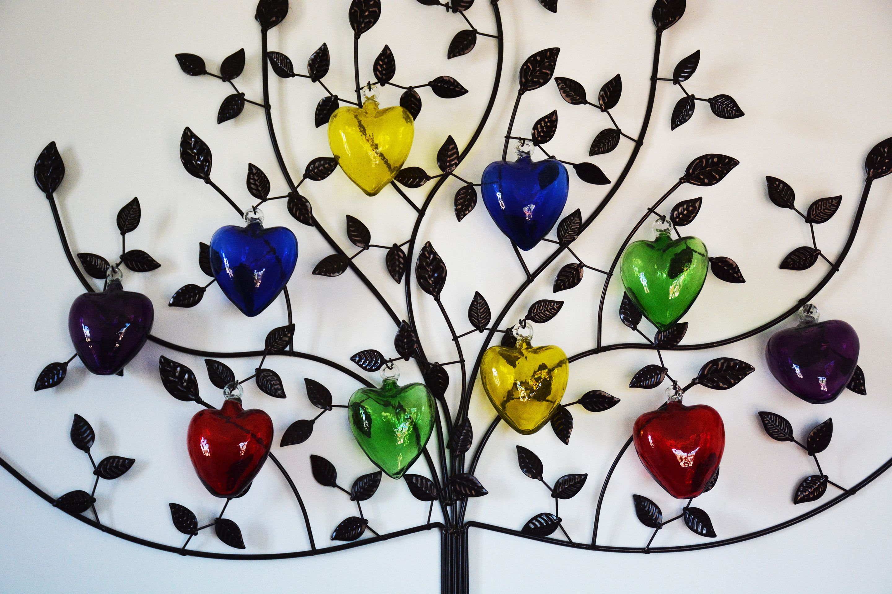 A decorative metal tree with heart-shaped ornaments in various colors.