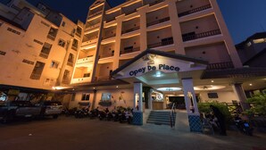 A multi-story hotel with a sign reading "Opey De Place" at the entrance. - Opey De Place (Pattaya)