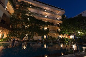 A multi-story building with a rooftop garden and a swimming pool. - Opey De Place (Pattaya)