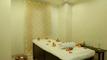 Experience relaxation in this serene spa room, featuring a massage table and a peaceful atmosphere.