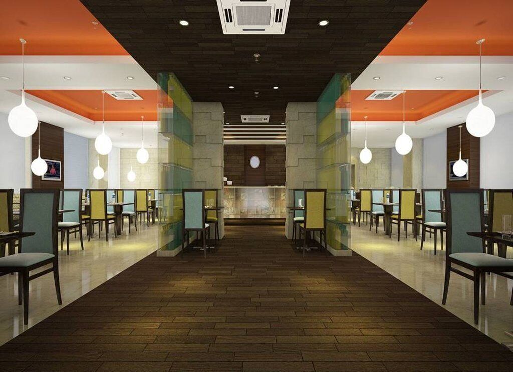 A spacious restaurant with a central counter and multiple seating areas.