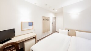A hotel room with a bed, a desk, a television, and a wardrobe. - Hotel Le Botejour Nanba (Osaka)