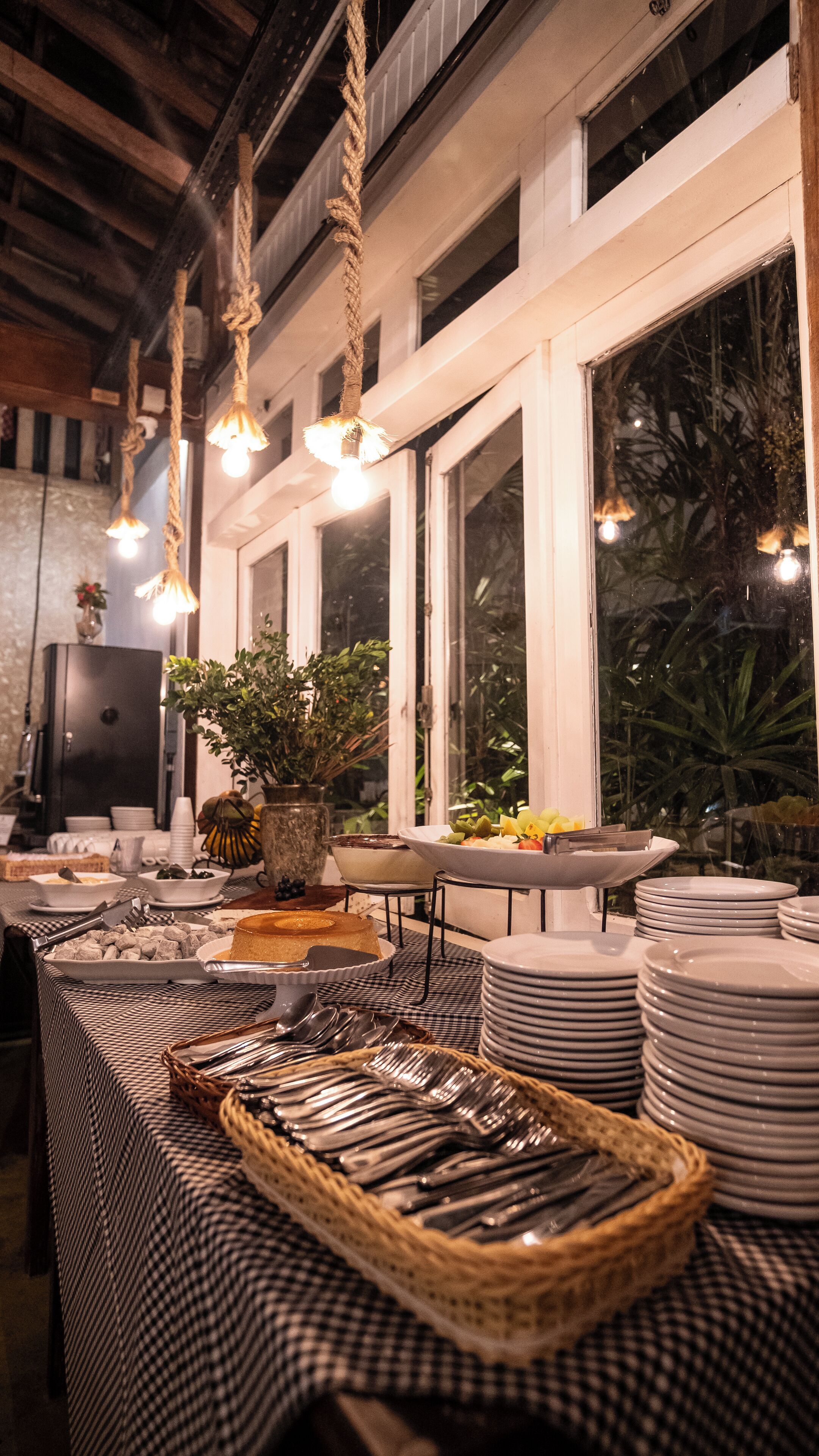 Un buffet avec plusieurs points de service, une grande variété de plats et des luminaires suspendus.