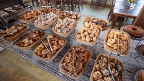 A buffet table with various baked goods. - Ville Real Hotel (Ouro Preto)