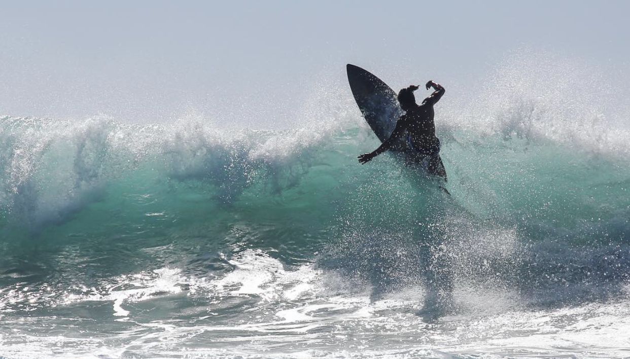 A surfer riding a large wave.