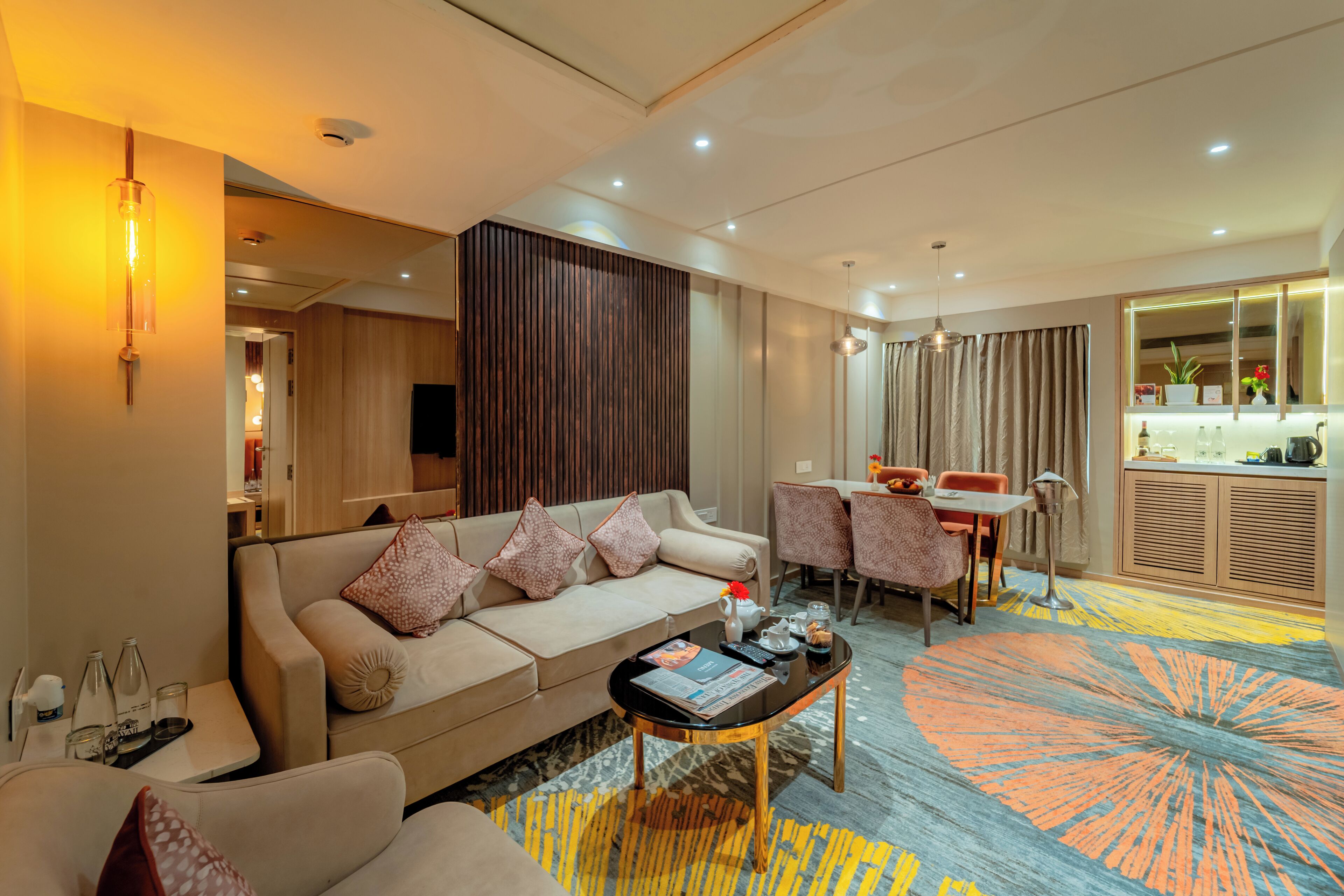 A modern living room with a sofa, coffee table, and dining area.
