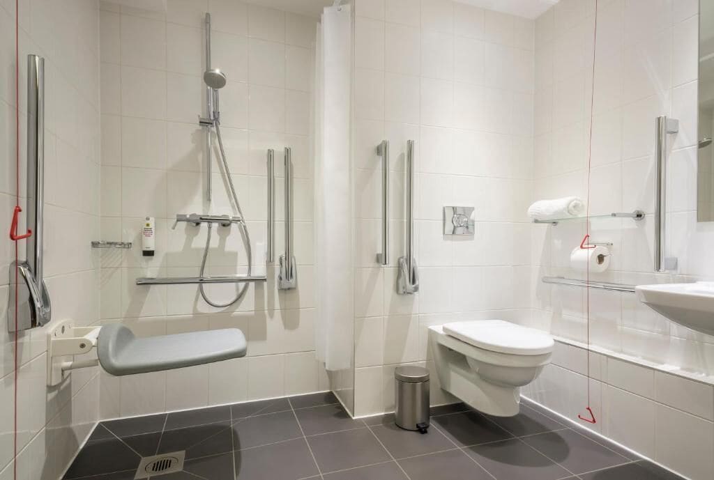 double room, roll-in shower, no windows | bathroom | shower, free toiletries, hair dryer, towels
