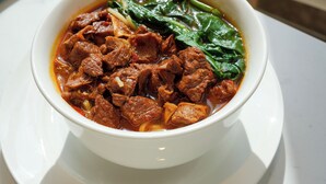 A bowl of soup on a white plate on a table. - EVEN Hotel Hangzhou Yintai City by IHG (Hangzhou)