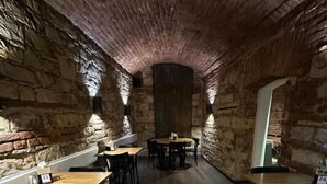 A narrow, stone-walled interior with wooden tables and chairs, suggesting a rustic dining area. - Wenceslas Square Hotel - Czech Leading Hotels (Prague)