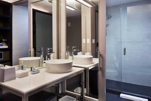Shower, designer toiletries, hair dryer, towels